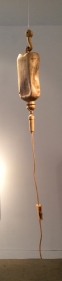 A IV drip, scaled up and hand carved out of wood.